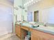 Bathroom with walk-in shower, neutral tile, and double sinks at 341 Whittier St, Davenport, FL 33896