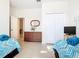 Bright bedroom with two twin beds and a dresser with a mirror at 341 Whittier St, Davenport, FL 33896