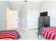 Bright bedroom featuring twin beds, closet, and a dresser with television at 341 Whittier St, Davenport, FL 33896