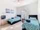 Bright bedroom with two twin beds and a large window at 341 Whittier St, Davenport, FL 33896