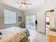 Cozy bedroom with ceiling fan, neutral walls, access to the lanai, and bright natural light at 341 Whittier St, Davenport, FL 33896