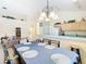Open-concept dining area adjacent to the kitchen, featuring tiled floors and barstool seating at 341 Whittier St, Davenport, FL 33896