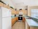 Well-equipped kitchen with classic appliances, practical layout, and smooth countertops at 341 Whittier St, Davenport, FL 33896