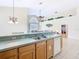Open-concept kitchen with bar counter overlooking the living room, and modern appliances at 341 Whittier St, Davenport, FL 33896