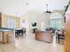 Bright living room with tile flooring, vaulted ceilings, and direct access to outdoor space at 341 Whittier St, Davenport, FL 33896
