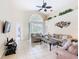 Bright living room with tile floors, high ceilings, comfortable seating, and a view of the pool at 341 Whittier St, Davenport, FL 33896