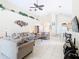 Spacious living room with tile floors, high ceilings, ample seating, and open floor plan at 341 Whittier St, Davenport, FL 33896