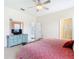Bright main bedroom showcasing tile flooring, ceiling fan, and bathroom access at 341 Whittier St, Davenport, FL 33896