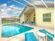 Beautiful pool area with sun loungers and seating, surrounded by screened enclosure at 341 Whittier St, Davenport, FL 33896