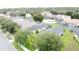 This is an aerial shot of a neighborhood showing houses with solar panels, screened pools, and green lawns at 350 Scrub Jay Way, Davenport, FL 33896