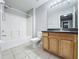 Bathroom with vanity, toilet, and bath with shower at 350 Scrub Jay Way, Davenport, FL 33896