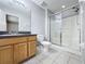 Well-lit bathroom with vanity, toilet, and glass enclosed shower at 350 Scrub Jay Way, Davenport, FL 33896