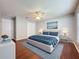 Comfortable bedroom with hardwood floors, a ceiling fan, and bright natural light at 350 Scrub Jay Way, Davenport, FL 33896
