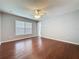 This bedroom features hardwood floors, natural lighting, a ceiling fan and ensuite bathroom at 350 Scrub Jay Way, Davenport, FL 33896