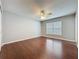 This bedroom features hardwood floors, natural lighting, and a ceiling fan at 350 Scrub Jay Way, Davenport, FL 33896