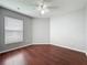 Bedroom with hardwood floors, natural lighting, and a ceiling fan at 350 Scrub Jay Way, Davenport, FL 33896
