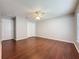 This bedroom features hardwood floors, natural lighting, a ceiling fan and closet at 350 Scrub Jay Way, Davenport, FL 33896