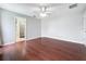 Open bedroom featuring hardwood floors, fan, and an ensuite bathroom with shower at 350 Scrub Jay Way, Davenport, FL 33896