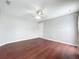 Clean, functional bedroom featuring hardwood floors, fan, and a single window at 350 Scrub Jay Way, Davenport, FL 33896
