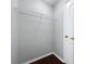 Walk-in closet with gray walls, wood floor and a single wire shelf for optimal storage at 350 Scrub Jay Way, Davenport, FL 33896