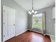 Cozy dining area with hardwood floors, chandelier, and window overlooking backyard at 350 Scrub Jay Way, Davenport, FL 33896