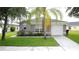 This well-maintained single-story house has a lawn, a simple landscape, and an attached one-car garage at 350 Scrub Jay Way, Davenport, FL 33896