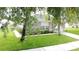 Charming single-Gathering home with lush green lawn, mature trees and neatly trimmed landscaping on a sunny day at 350 Scrub Jay Way, Davenport, FL 33896