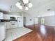 Bright and airy open-concept kitchen and living area with tile flooring and hardwood at 350 Scrub Jay Way, Davenport, FL 33896