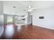 Open-concept living room and kitchen featuring vaulted ceilings, modern lighting, and wood flooring at 350 Scrub Jay Way, Davenport, FL 33896