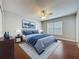 Comfortable main bedroom with hardwood floors, a ceiling fan, and bright natural light at 350 Scrub Jay Way, Davenport, FL 33896
