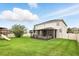 Spacious backyard with a screened lanai, a playset, and a well-maintained lawn, perfect for outdoor activities at 3859 Spirited Cir, St Cloud, FL 34772