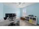 Bright bedroom features blue walls, a ceiling fan, and a large window with white shutters at 3859 Spirited Cir, St Cloud, FL 34772