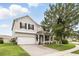 Charming two-story home with a brick driveway, a well-manicured lawn, and manicured shrubbery at 3859 Spirited Cir, St Cloud, FL 34772