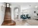 Open-concept foyer with stairs, an arched doorway, and a view of a living space at 3859 Spirited Cir, St Cloud, FL 34772
