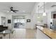 Spacious living area with sliding glass doors to the patio, ceiling fan, and kitchen view at 3859 Spirited Cir, St Cloud, FL 34772