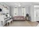 Open living room with a plush sofa, piano, and decorative curtains at 3859 Spirited Cir, St Cloud, FL 34772