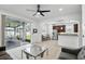 Spacious living area with a sliding glass door that leads to an outdoor patio and a partial kitchen view at 3859 Spirited Cir, St Cloud, FL 34772