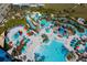 A resort-style community with pools, lazy river, lounge chairs, umbrellas, and lush tropical landscaping at 3878 Lana Ave, Davenport, FL 33897