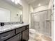 Clean bathroom featuring modern vanity, granite counters, and a glass door shower at 3878 Lana Ave, Davenport, FL 33897