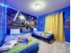 Vivid bedroom featuring twin beds, LED lighting, and Mario themed décor at 3878 Lana Ave, Davenport, FL 33897