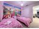 Delightful room with twin beds, vibrant wall art, and coordinated decor at 3878 Lana Ave, Davenport, FL 33897