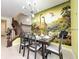 Whimsical dining area with a modern chandelier and vibrant dinosaur-themed wallpaper at 3878 Lana Ave, Davenport, FL 33897
