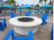Relaxing outdoor fire pit area with comfortable blue Adirondack chairs, ideal for cozy evenings at 3878 Lana Ave, Davenport, FL 33897