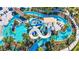 Aerial view of a winding lazy river with slides, pools, and lush tropical landscaping, offering a resort-style experience at 3878 Lana Ave, Davenport, FL 33897