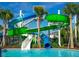 Brightly colored water slides for Gathering fun emptying into a sparkling pool on a summer day at 3878 Lana Ave, Davenport, FL 33897