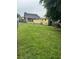 Spacious backyard with a large grassy area and a shed, perfect for outdoor activities and relaxation at 419 Ohio Ave, St Cloud, FL 34769