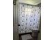 Cozy bathroom with decorative floral shower curtain at 419 Ohio Ave, St Cloud, FL 34769