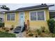 Charming home with a yellow exterior, well-maintained front yard, and inviting entryway with a welcome sign at 419 Ohio Ave, St Cloud, FL 34769