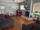 Comfortable living room featuring hardwood floors, fireplace, and natural light at 419 Ohio Ave, St Cloud, FL 34769