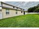 A spacious backyard featuring lush green grass and a white fence, offering privacy and ample outdoor space at 4368 Fox Glen Loop, Kissimmee, FL 34746
